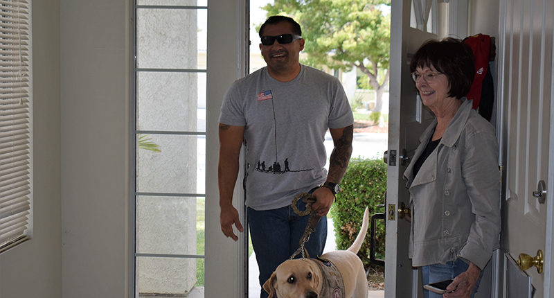 Sgt Danny Novoa and his service dog arriving at his newly furnished home